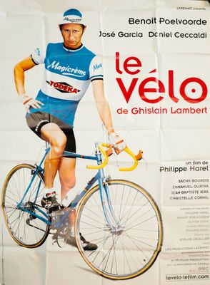 poster of a man riding a bike on a wall in a room