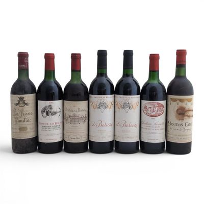 six bottles of wine are lined up in a row on a white surface