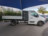 a white truck parked under a blue umbrella in a parking lot