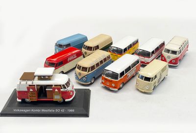 a lot of miniature buses that are lined up together