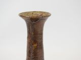 a brown vase that is sitting on a table