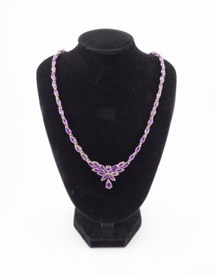 a necklace with purple beads on a black mannequin