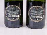 two bottles of wine sitting next to each other on a white surface