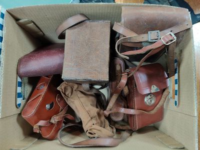 a cardboard box filled with many different types of bags