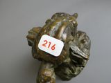 a small statue of a turtle with a price tag on it ' s back