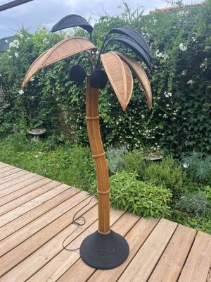 a lamp that has a palm tree on top of it