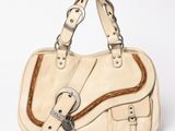 beige leather handbag with metal buckles on a white background