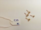 three screws and a tag on a white surface