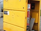 a yellow box that is sitting outside of a building