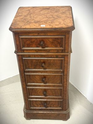 a small wooden chest of drawers with drawers on top of it