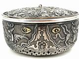 an image of a silver box with flowers on it on a white surface