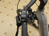 a close up of a bicycle handlebar with a cell phone on it