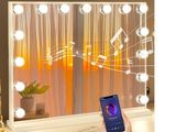a person holding a smart phone in front of a lighted mirror
