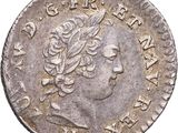 a silver coin with a woman ' s head on it