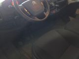 a car with a steering wheel and dashboard in a garage