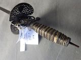 a picture of a sword with a bow on top of it