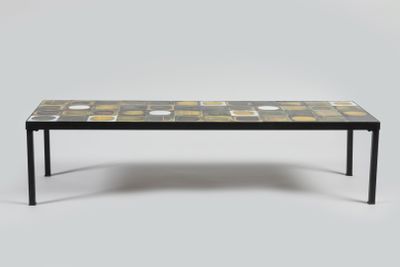 a black table with yellow and white tiles on it