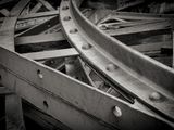 black and white photograph of a pile of steel beams in a warehouse
