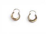 a pair of gold hoop earrings on a white background