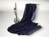 a blue scarf hanging on a clothes rack next to a vase