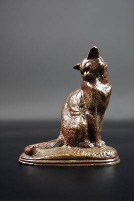 un gros plan sur la statue d'un chat assis sur une table