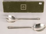 two spoons and a spoon on a table