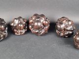 six antique silver plated figurines of flowers on a gray background