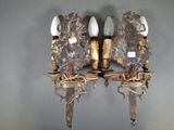 two sconces that are attached to a wall