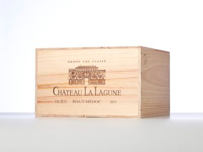 a close up of a wooden box with a bottle of wine in it