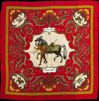 a red banda with a picture of a horse and rider on it