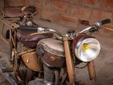 a old motorcycle that is sitting in the dirt