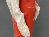 an image of a woman in a white shirt and red skirt