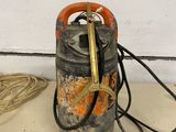 a gas can with a hose attached to it on the floor