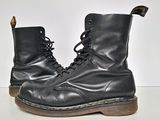 pair of black leather boots on a white surface with a white background