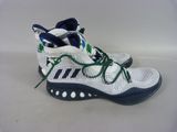 adidas basketball shoes with green laces and a white background
