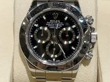 a rolex watch with a black dial on display