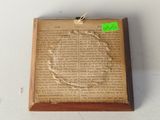 a picture of an old book with a green sticker on it