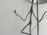 statue of a man with a lamp and a mirror on a table