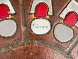 a close up of a decorative piece of art on the ground