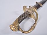 an old sword with a wooden handle on a white surface
