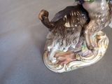 a figurine of a dog with a flower in its mouth