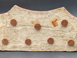 a close up of a piece of stone with dots on it