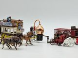 a lot of toy horses and carriages on a white surface
