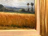 a painting of a field of wheat in a gold frame