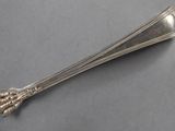 a silver spoon with a flower on it on a table