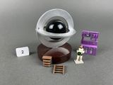 a toy that is sitting on a table next to a camera