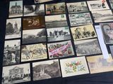 many old postcards on a table with a black table cloth