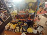 a lot of anime figures on display in a store
