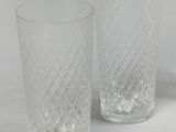 three clear glass vases sitting next to each other on a white surface