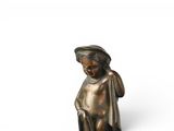 bronze figurine of a woman sitting on a stool